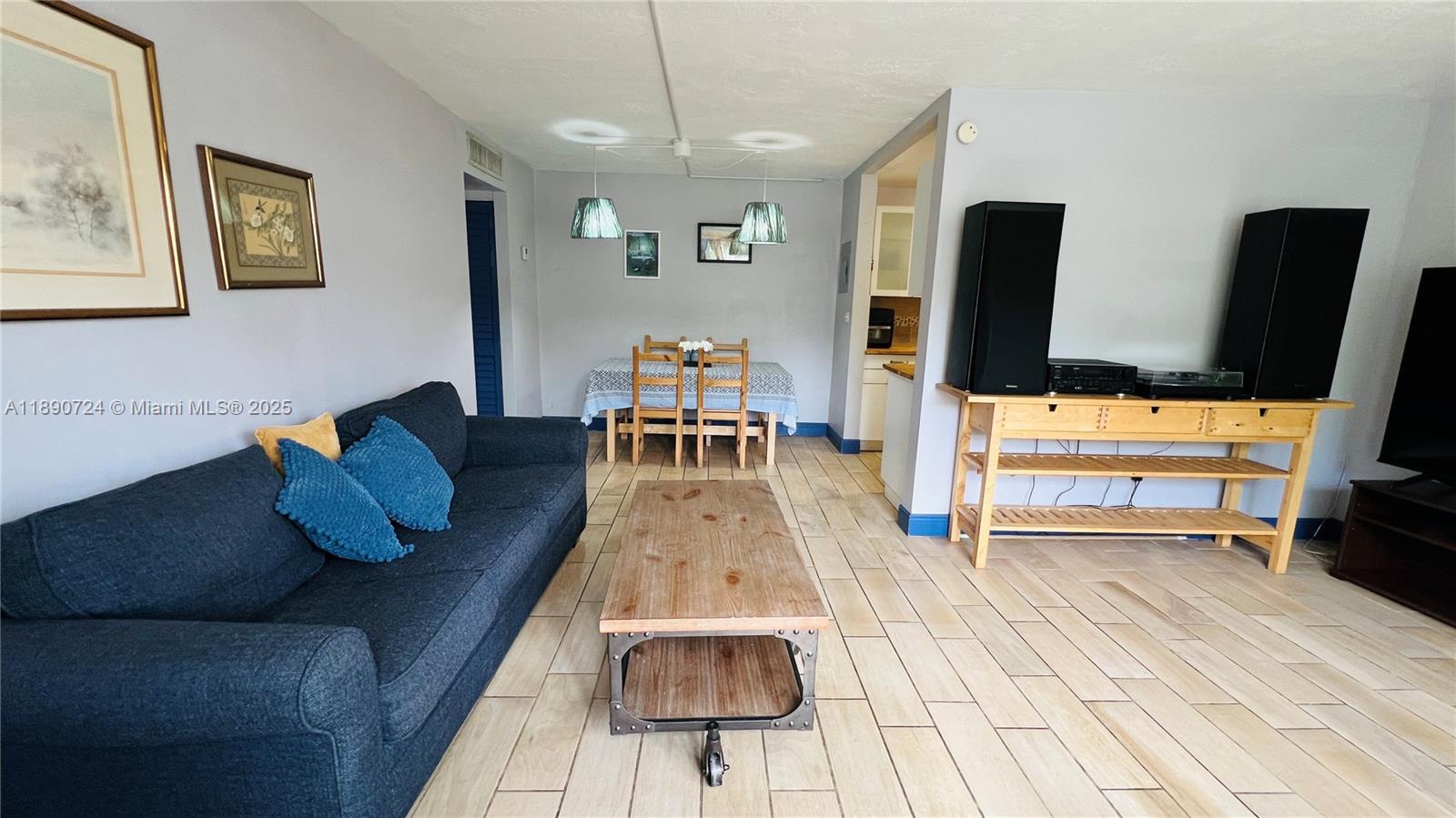 801 Meridian Avenue, Unit 1A Miami Beach, FL 33139 - Photo 4 of 18 a living room with furniture and a flat screen tv