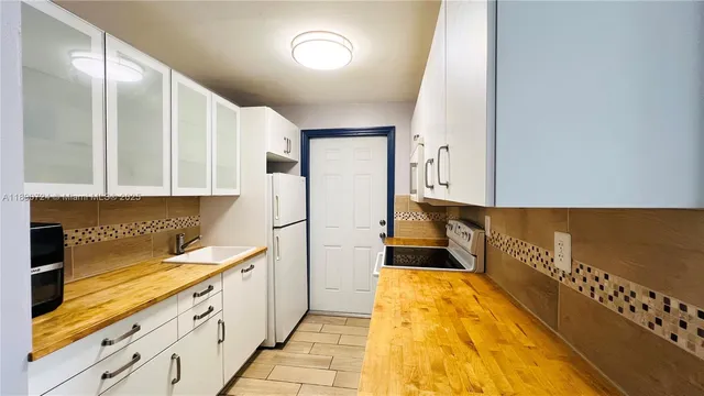 a kitchen with sink cabinets and window