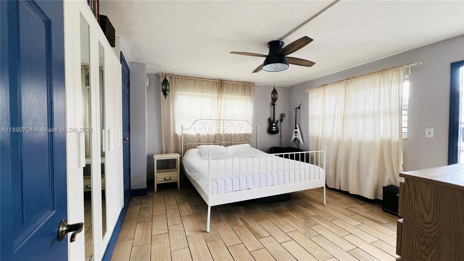 801 Meridian Avenue, Unit 1A Miami Beach, FL 33139 - Photo 9 of 18 a bedroom with a bed and a window