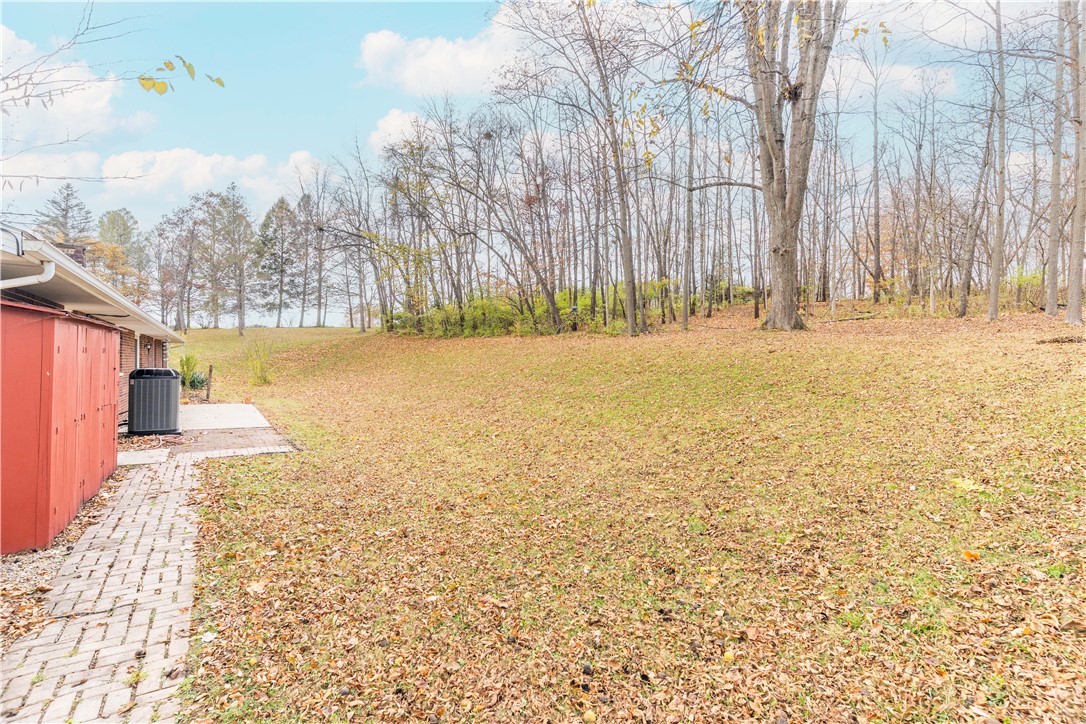 18333 Lefevre Number 2 Road Sidney, OH 45365 - Photo 9 of 25 Expansive outdoor space with a paved pathway, ideal for tranquil moments or lively gatherings.