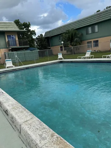 a view of swimming pool with outdoor seating and yard