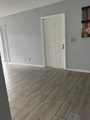 an empty room with wooden floor