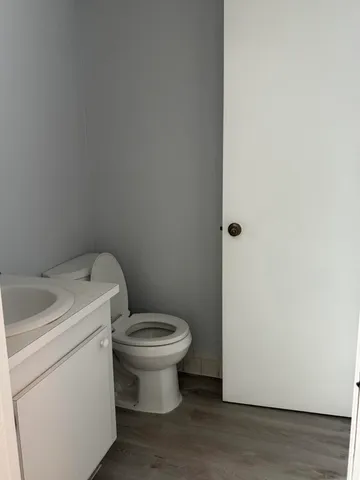 a white toilet sitting next to a sink