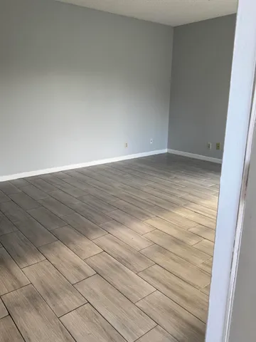 a view of a room with wooden floor