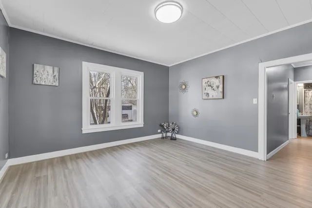 wooden floor in an empty room with a window
