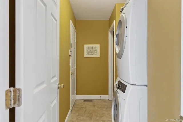 a view of a hallway with wooden floor and door