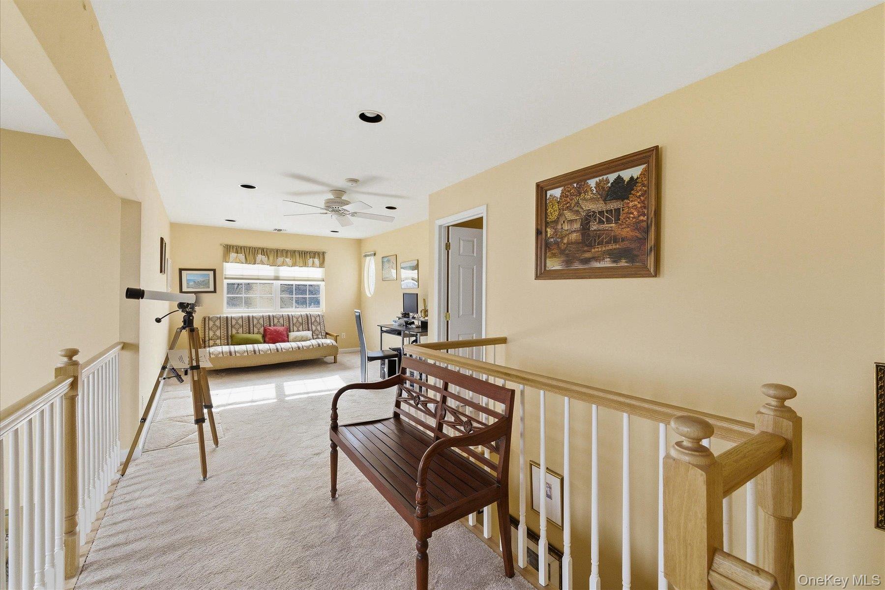 23 Goose Neck Lane Riverhead, NY 11901 - Photo 17 of 28 a living room with furniture and a wooden floor