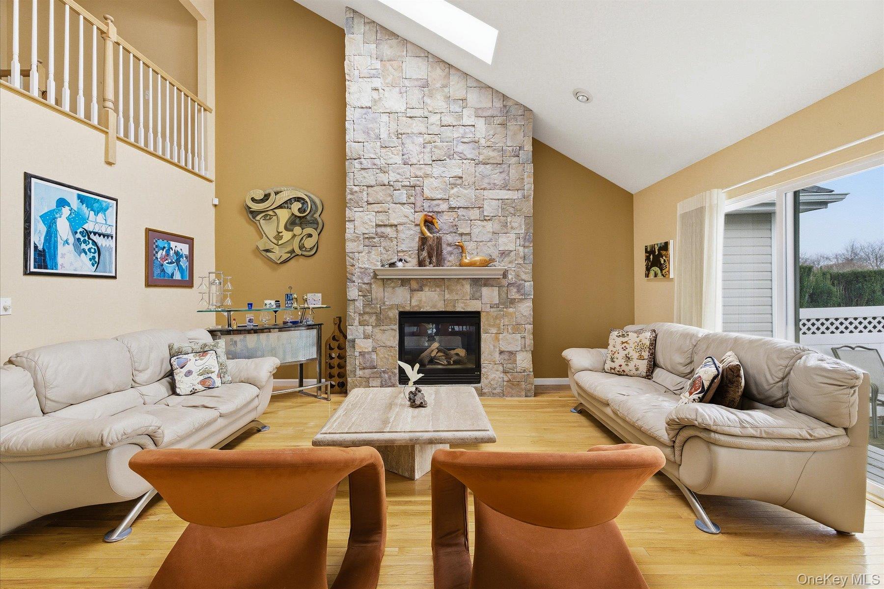 23 Goose Neck Lane Riverhead, NY 11901 - Photo 5 of 28 a living room with furniture and a fireplace