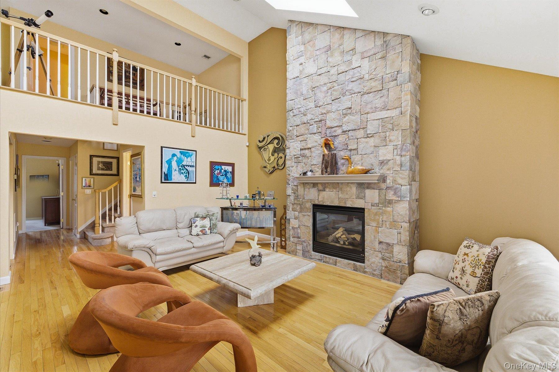 23 Goose Neck Lane Riverhead, NY 11901 - Photo 7 of 28 a living room with furniture and a fireplace
