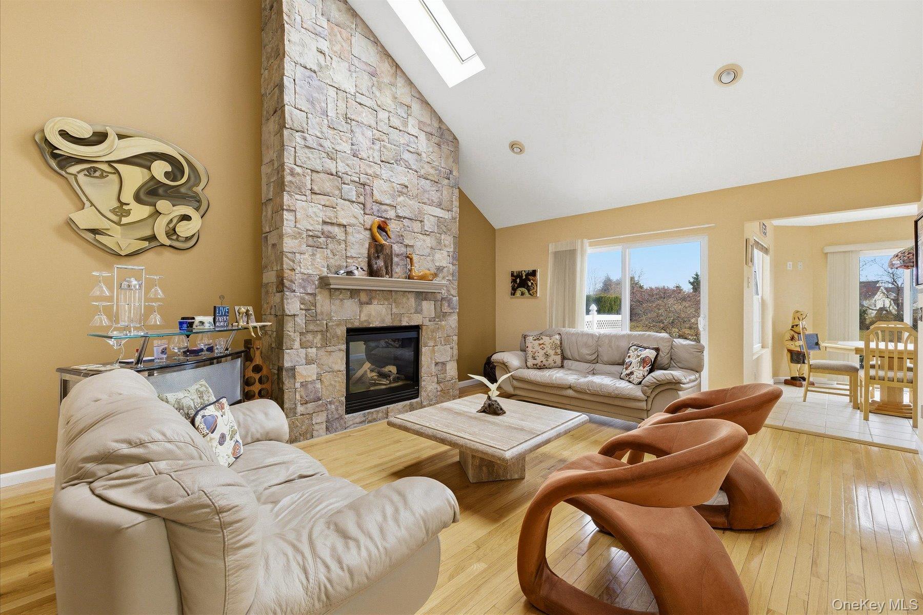 23 Goose Neck Lane Riverhead, NY 11901 - Photo 8 of 28 a living room with furniture and a fireplace