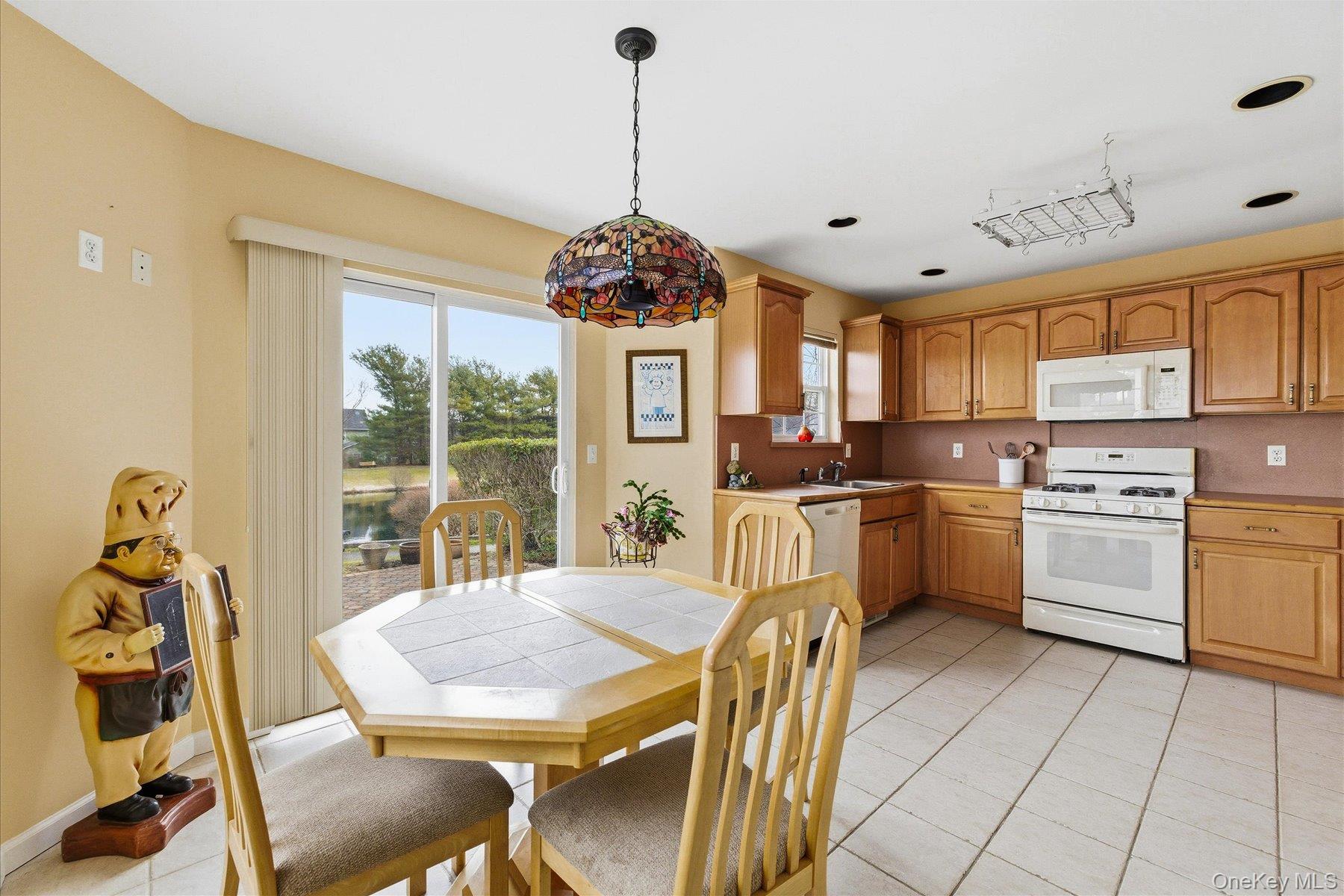 23 Goose Neck Lane Riverhead, NY 11901 - Photo 9 of 28 a kitchen with furniture a center island stainless steel appliances cabinets and a counter top space