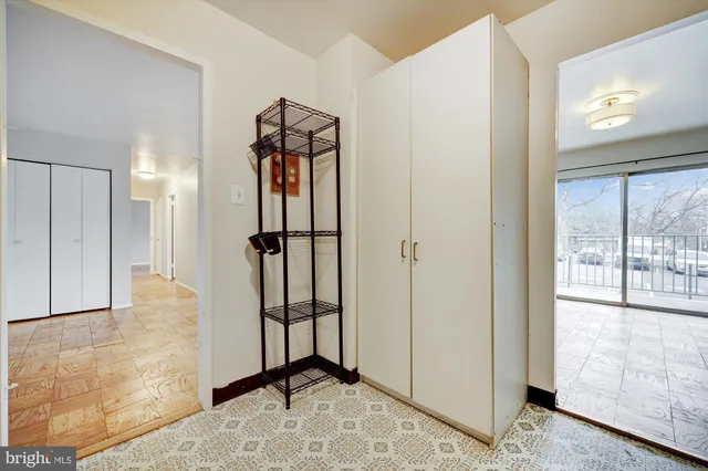 a view of a hallway with a shower and closet