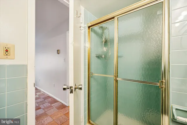 a bathroom with a glass shower door