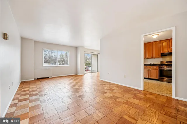 a view of a kitchen with wooden floor and a window