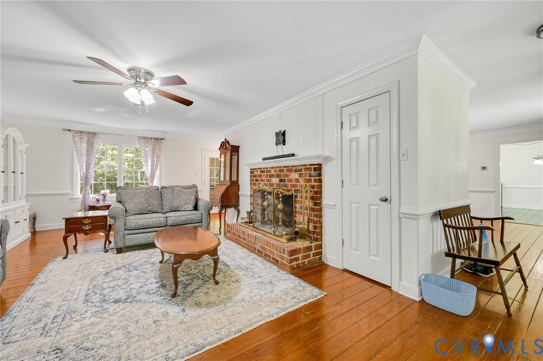 2409 Three Bridge Road Powhatan, VA 23139 - Photo 15 of 39 Brick fireplace with a metal grate, wood-finish fl