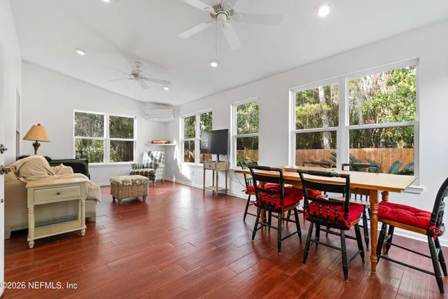 a view of a dining room with furniture window and wooden floor
