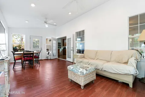 a living room with furniture and a wooden floor