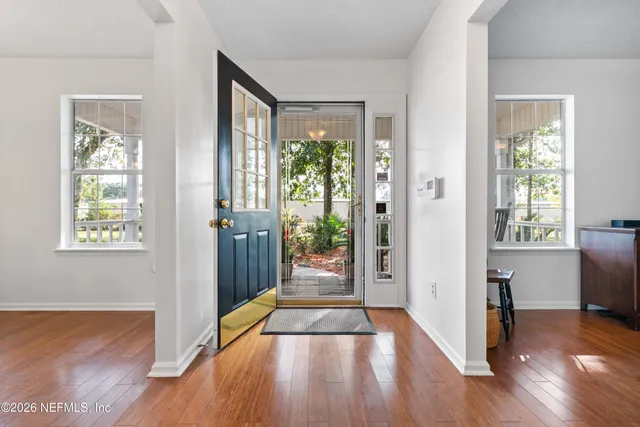 a view of entryway with wooden floor and door