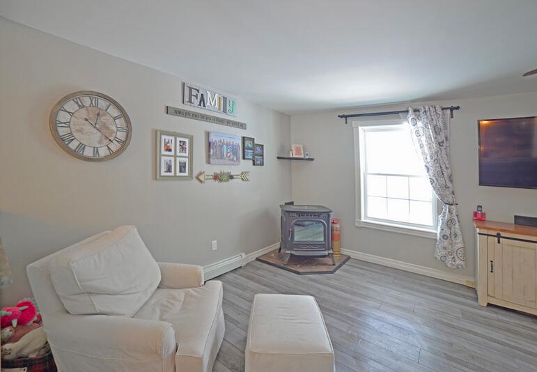 214 Roux Road Lyman, ME 04002 - Photo 10 of 27 Pellet stove in Living room