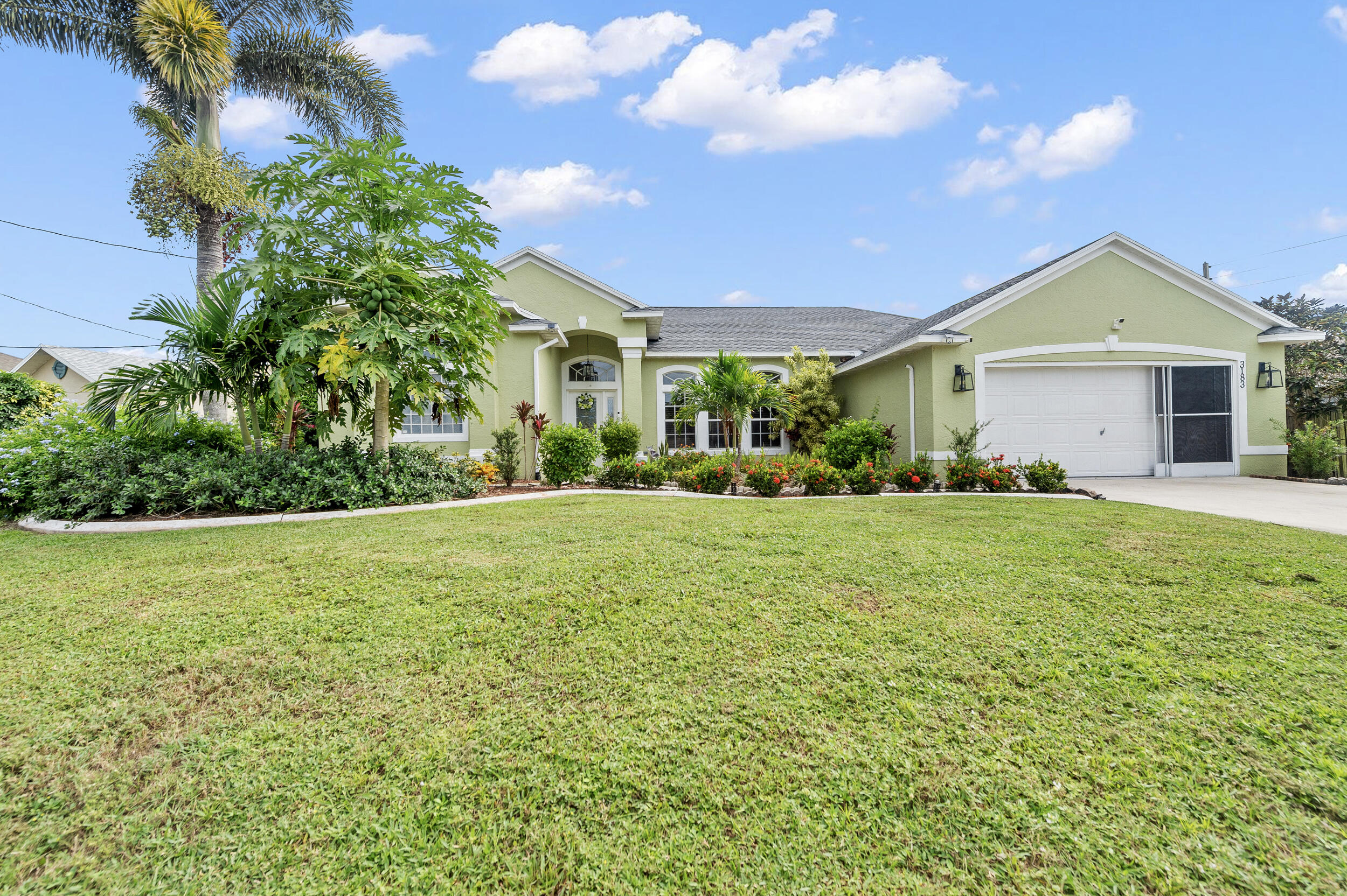 3183 Southwest Ann Arbor Road Port St. Lucie, FL 34953 - Photo 1 of 16 a front view of house with yard and green space
