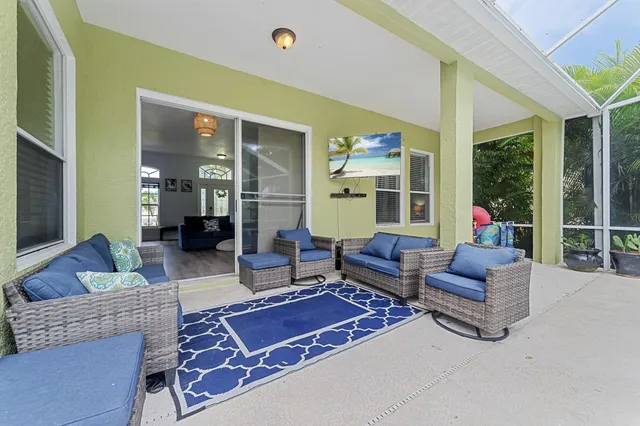 a living room with furniture rug and a large window