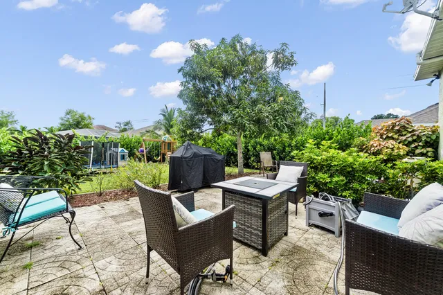 a view of a chairs and table in the patio
