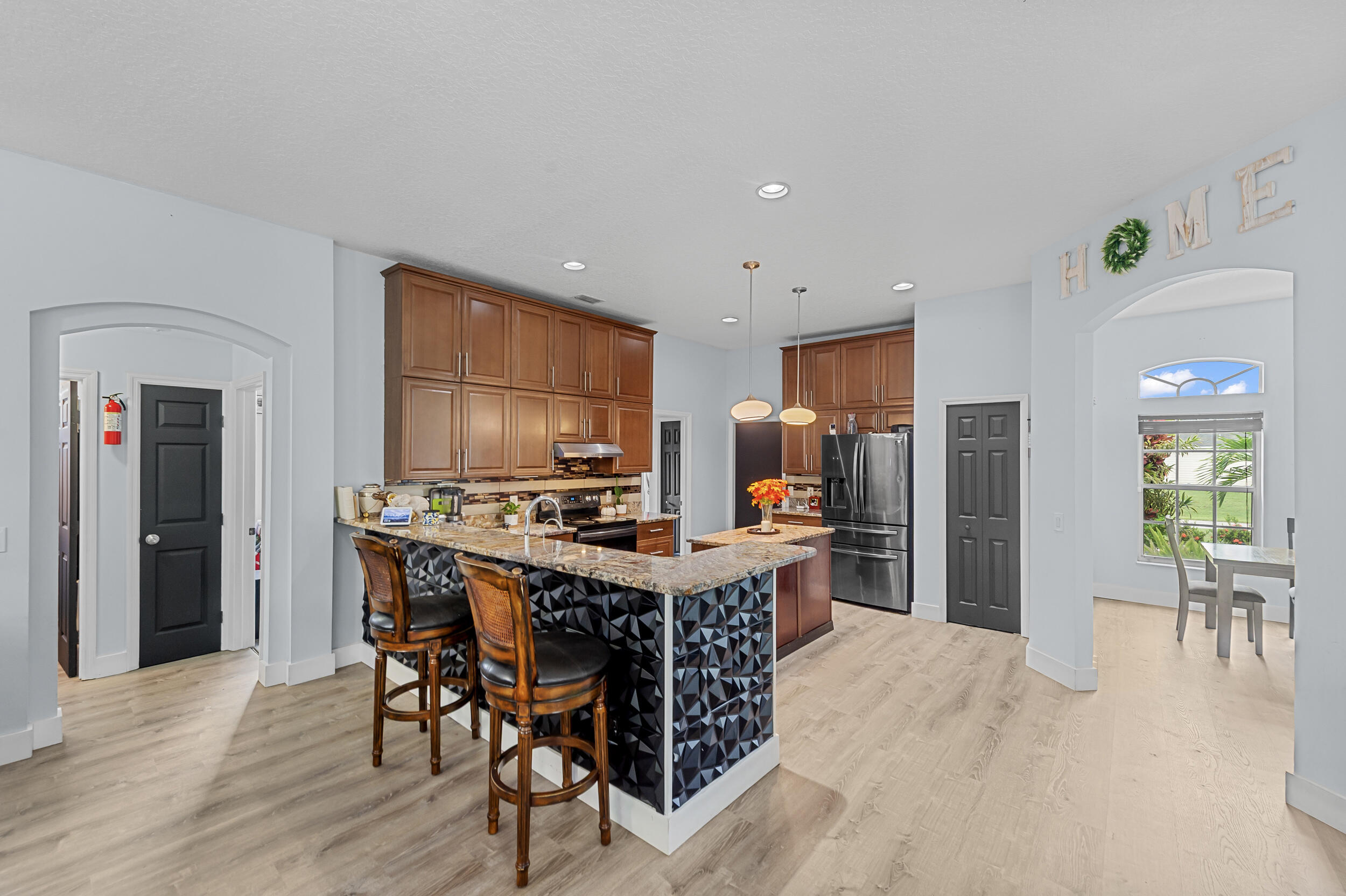 3183 Southwest Ann Arbor Road Port St. Lucie, FL 34953 - Photo 4 of 16 a view of a dining room with furniture window and wooden floor