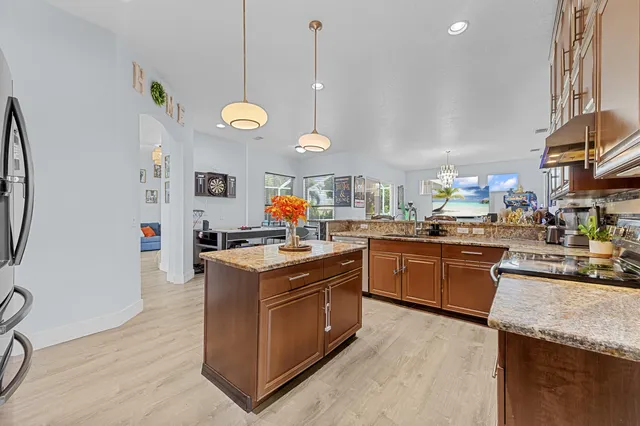 a kitchen with cabinets and wooden floor
