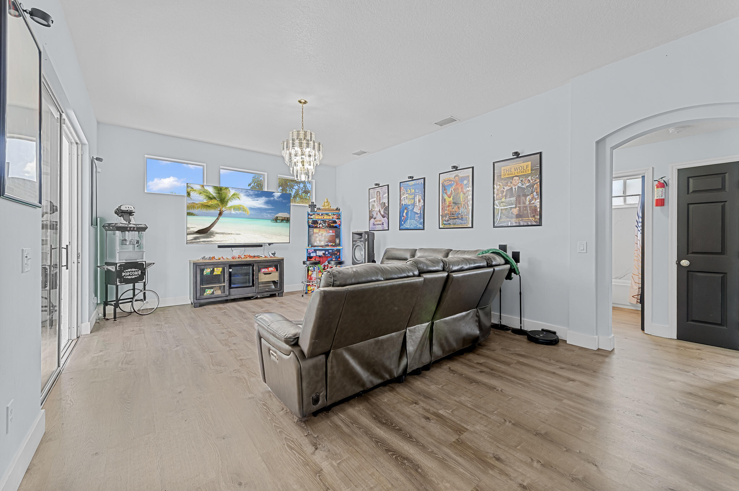 3183 Southwest Ann Arbor Road Port St. Lucie, FL 34953 - Photo 9 of 16 a living room with furniture and a fireplace