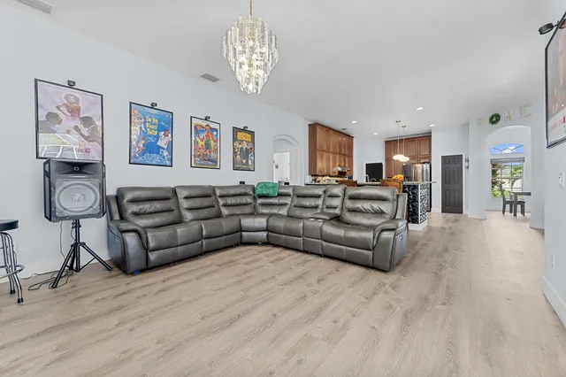 a living room with furniture and a chandelier