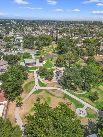 an aerial view of residential houses with outdoor space and trees