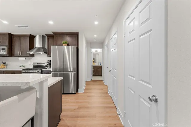 a kitchen with refrigerator and a sink
