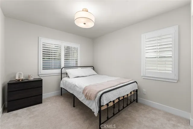 a bedroom with a bed lamp and window