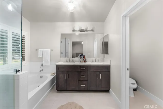 a bathroom with a tub sink and mirror
