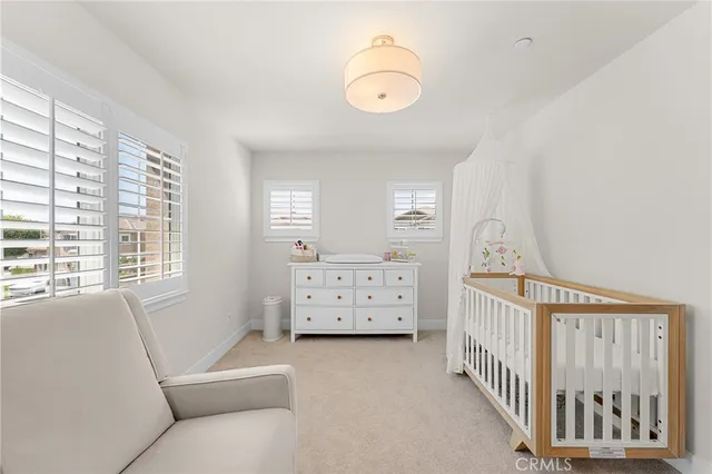 a view of a bedroom with furniture and windows