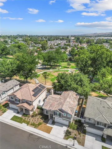 an aerial view of residential houses with outdoor space and ocean view
