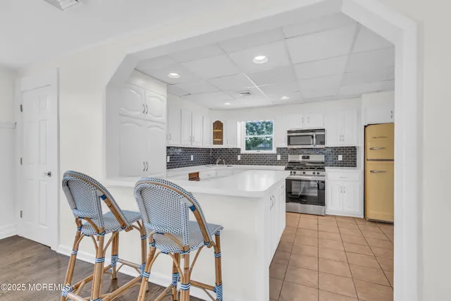 a kitchen with stainless steel appliances a refrigerator stove microwave and cabinets