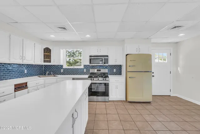 a kitchen with refrigerator and stove