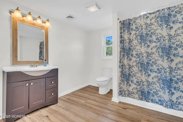 a view of a patio with table and chairs with wooden fence and plants