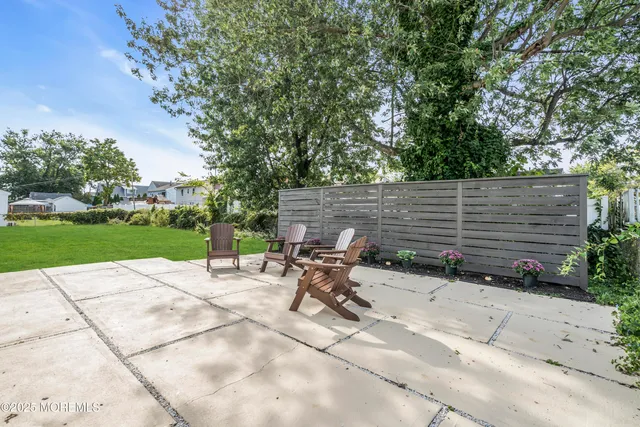 a backyard of a house with table and chairs