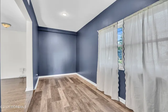a view of bedroom with wooden floor