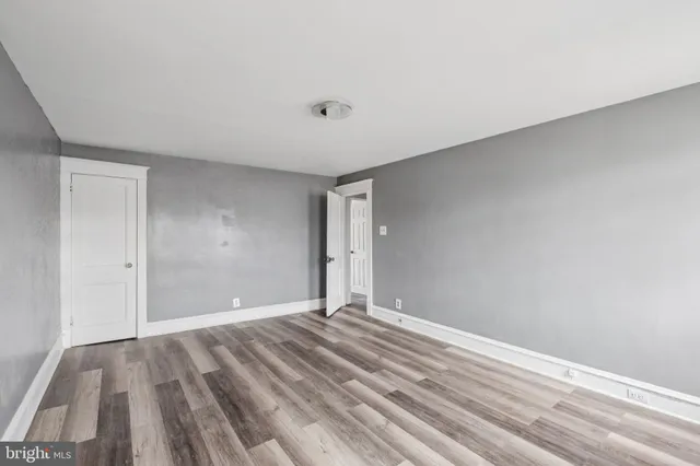 a view of room with wooden floor