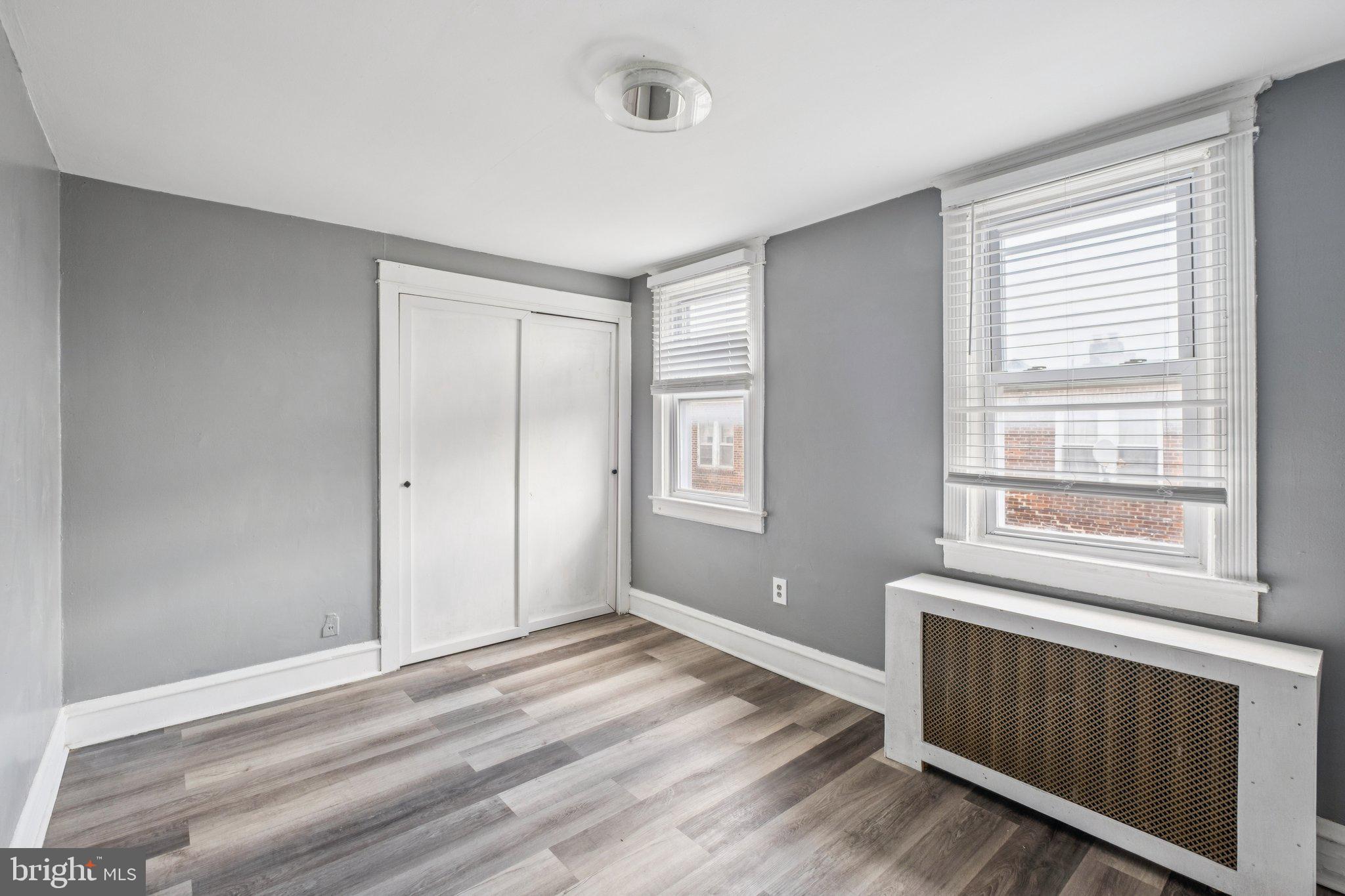 235 Ashby Road Upper Darby, PA 19082 - Photo 15 of 30 a view of an empty room with wooden floor and a window