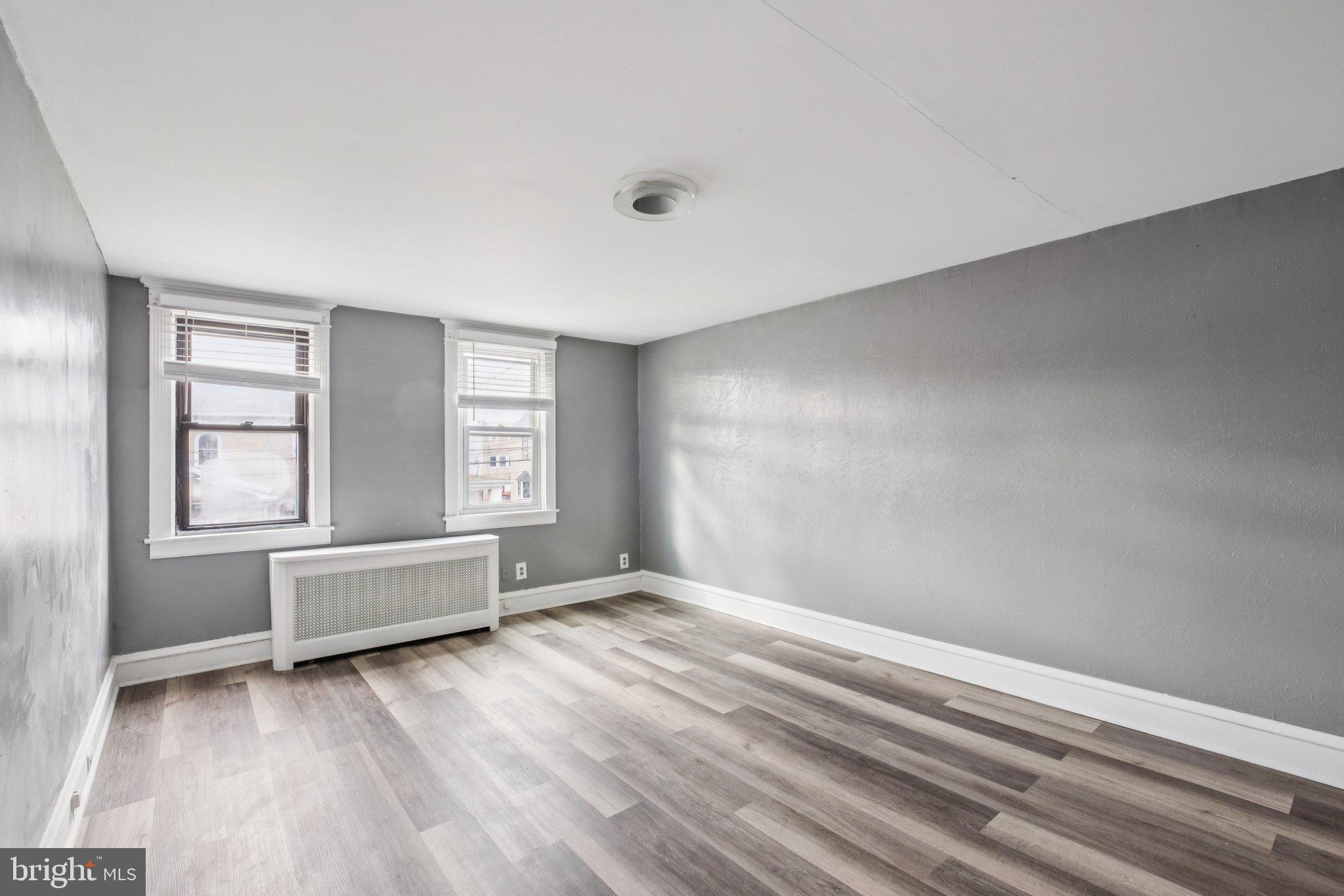235 Ashby Road Upper Darby, PA 19082 - Photo 16 of 30 wooden floor in an empty room with a window