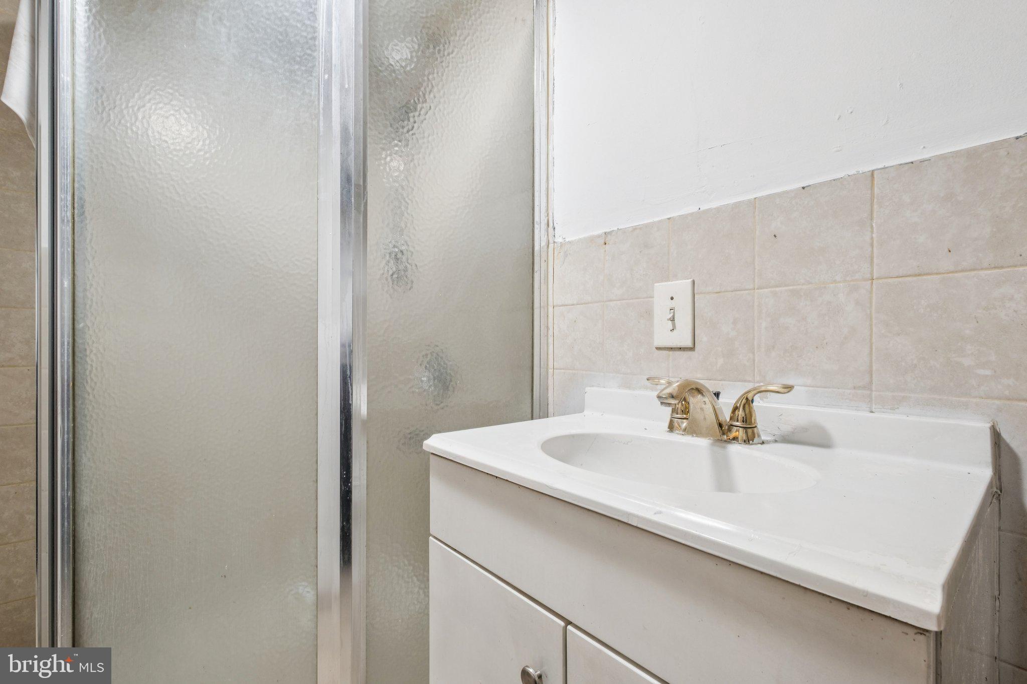 235 Ashby Road Upper Darby, PA 19082 - Photo 19 of 30 a bathroom with a sink and a mirror