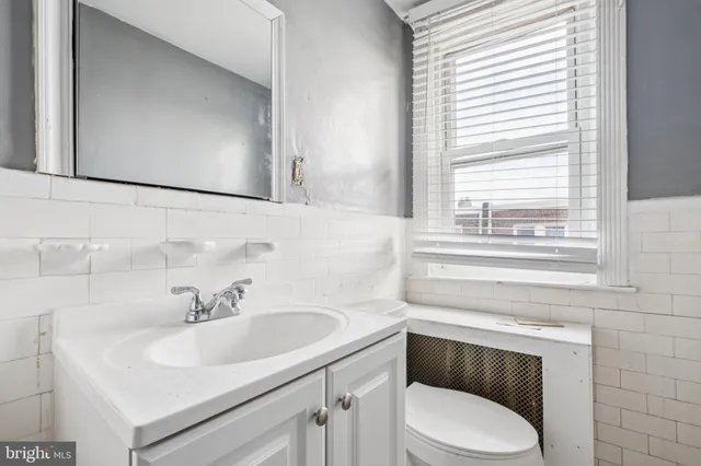 a bathroom with a sink and a window