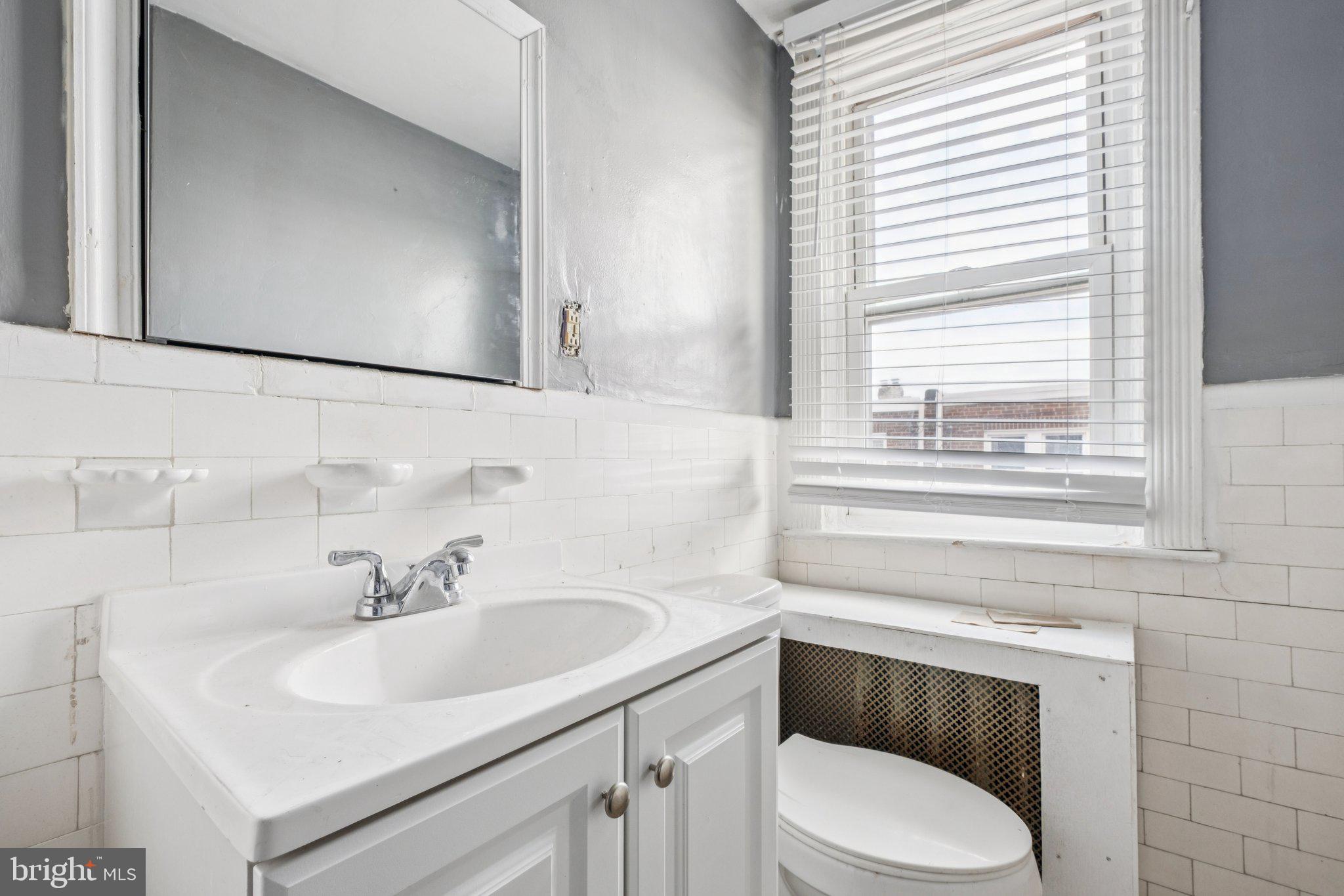 235 Ashby Road Upper Darby, PA 19082 - Photo 20 of 30 a bathroom with a toilet sink and mirror