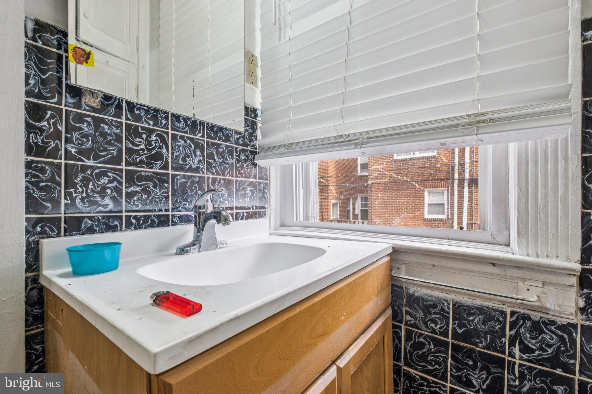 235 Ashby Road Upper Darby, PA 19082 - Photo 21 of 30 a bathroom with a sink and a window