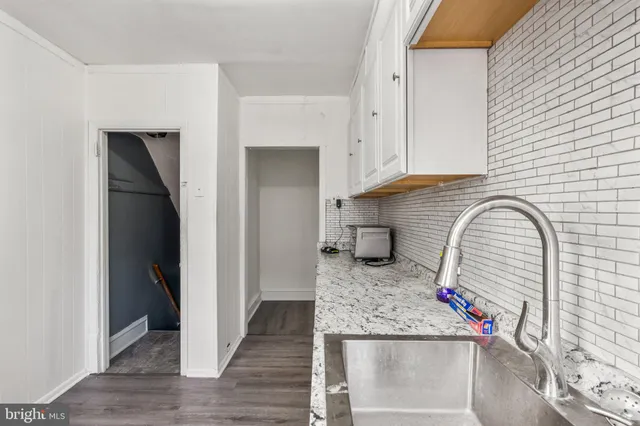 a kitchen with stainless steel appliances granite countertop a refrigerator and a stove