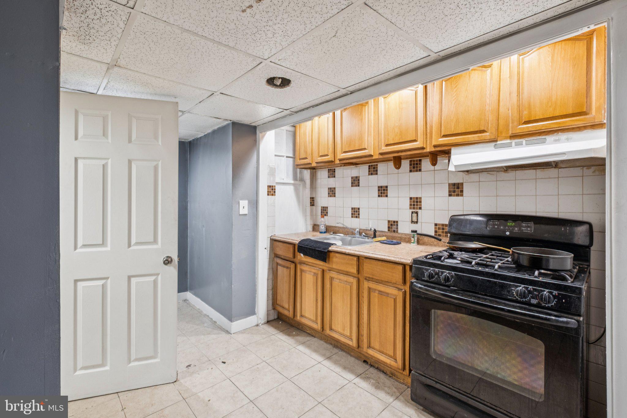 235 Ashby Road Upper Darby, PA 19082 - Photo 8 of 30 a kitchen with granite countertop a stove and a sink
